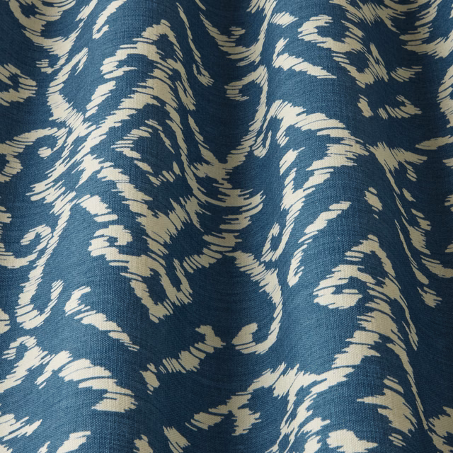 Denim blue woven fabric with bold cream wavy lattice pattern
