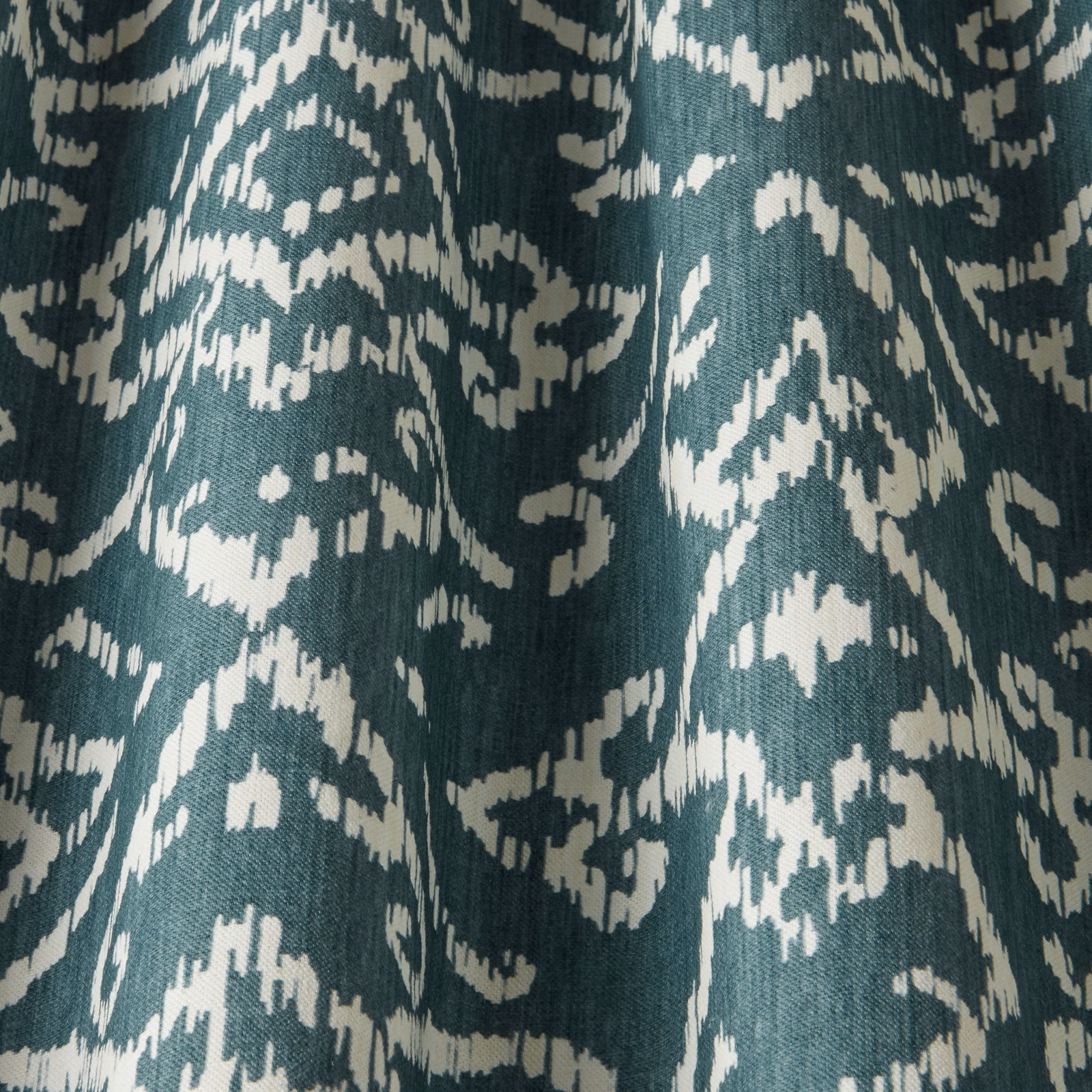 Teal cotton fabric with ivory abstract lattice motif and textured woven surface