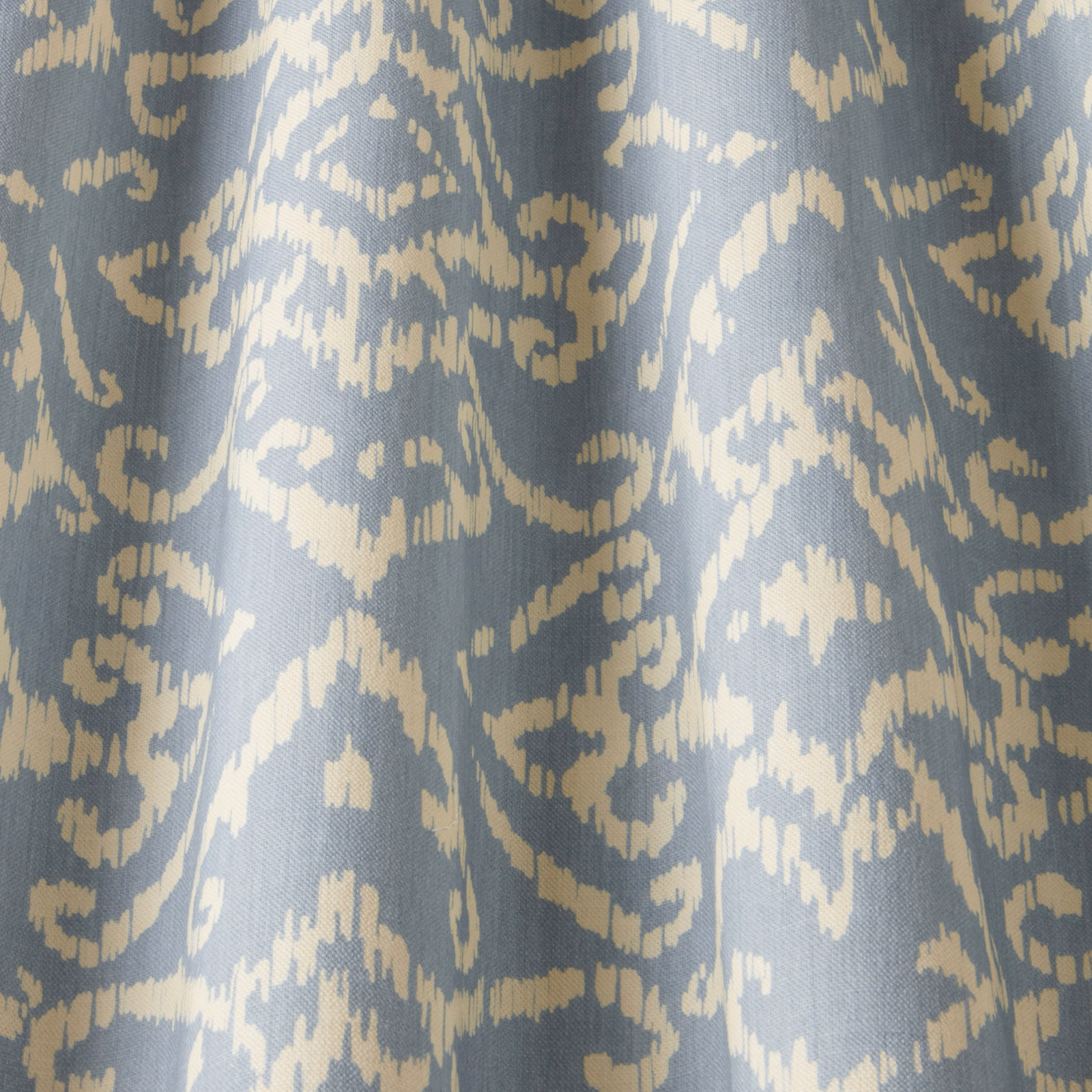 Blue cotton fabric with cream abstract lattice pattern and woven texture