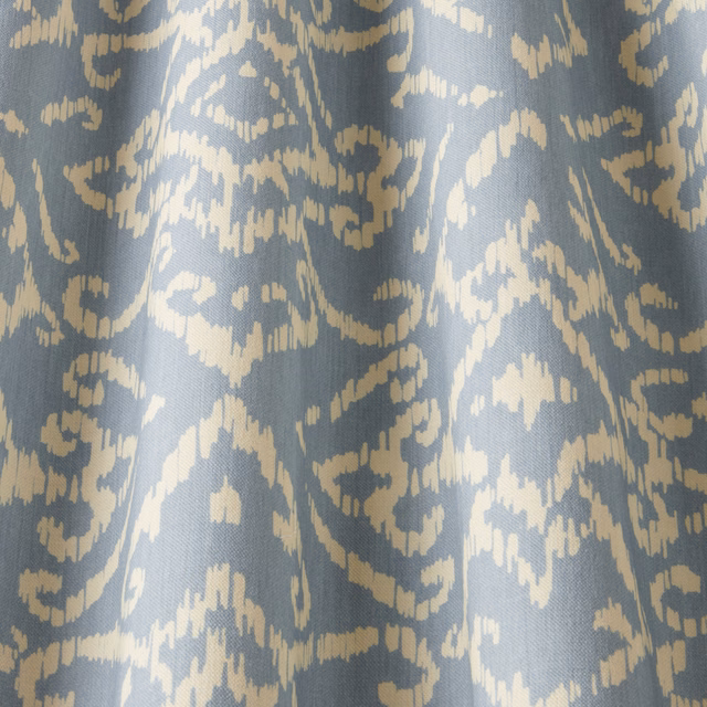 Blue cotton fabric with cream abstract lattice pattern and woven texture