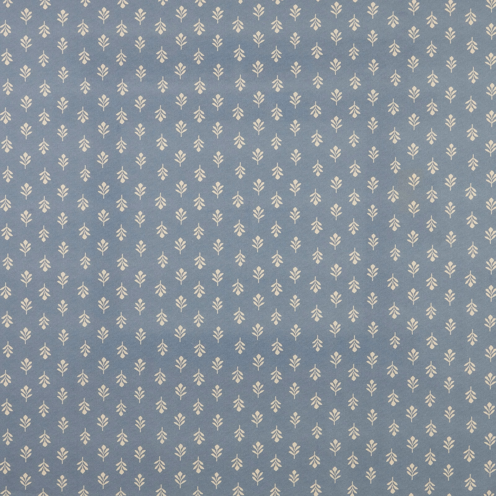 Cornflower blue cotton fabric with tiny cream leaf sprig repeat