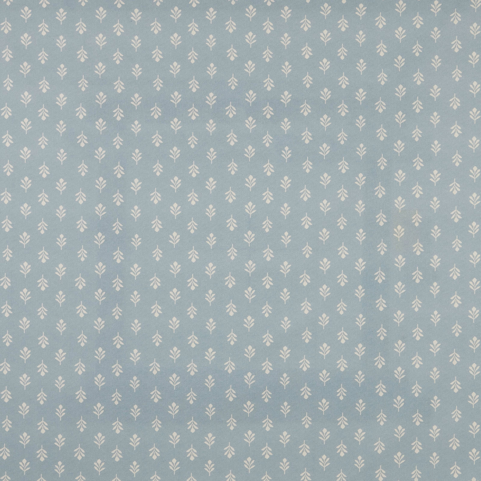 Pale sky blue cotton fabric with tiny ivory bud motif repeat