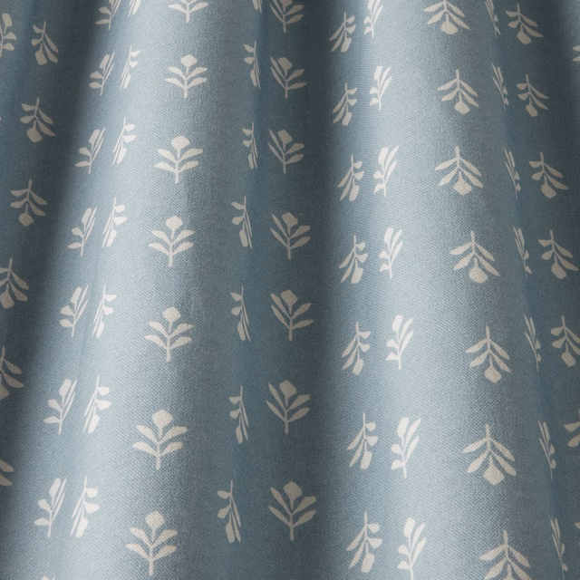 Soft sky blue cotton fabric with small pale botanical sprigs