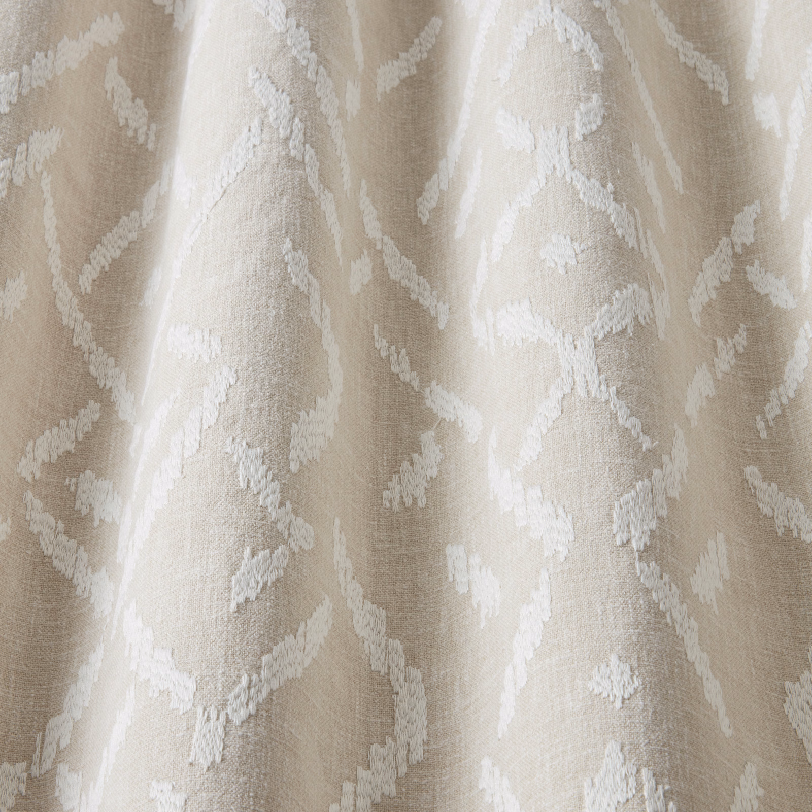 Cream cotton fabric with a raised wavy white pattern and soft texture