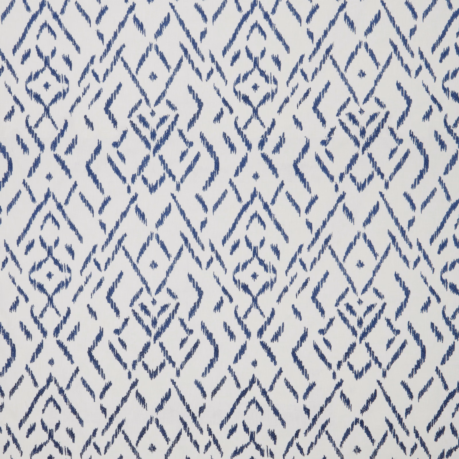 Blue geometric cotton fabric with diamond motifs on a pale ground