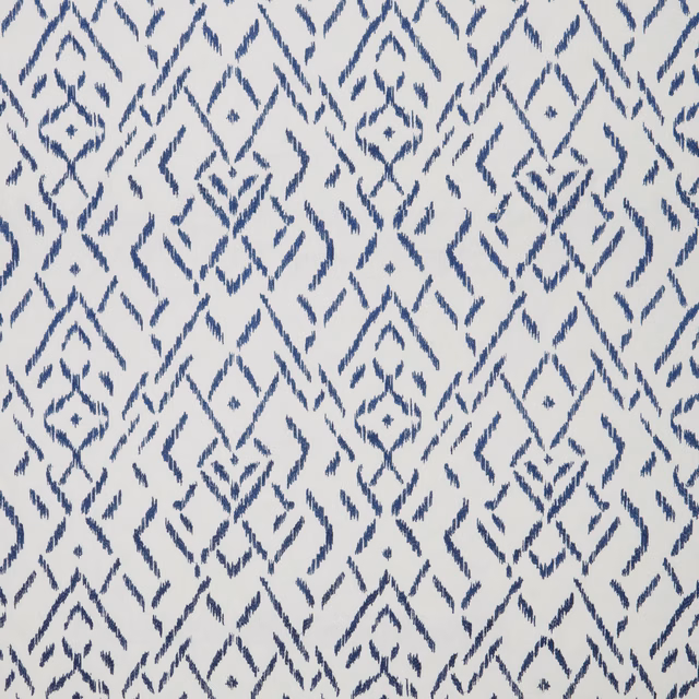 Blue geometric cotton fabric with diamond motifs on a pale ground