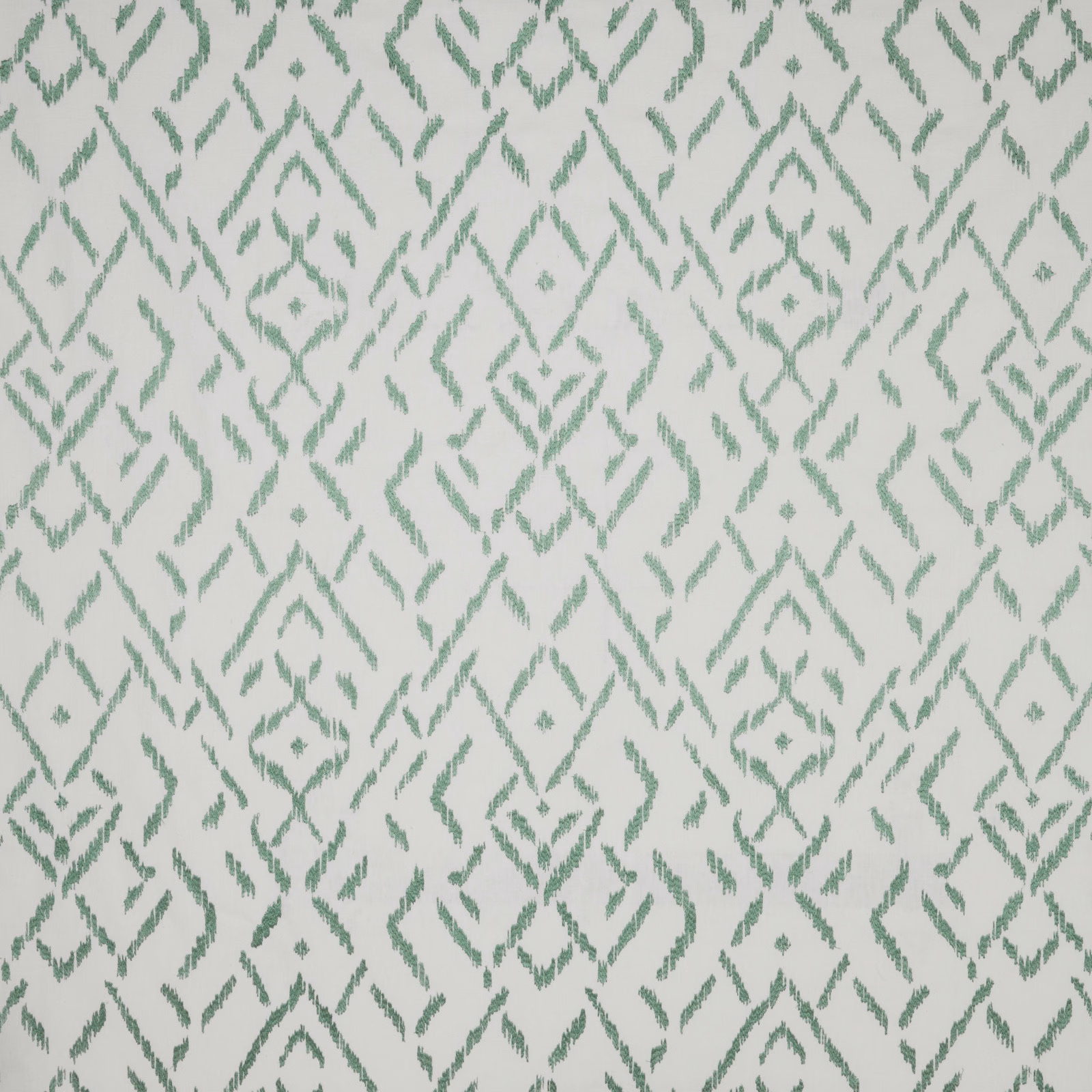 Sage green geometric cotton fabric on an ivory ground, repeating diamond motif