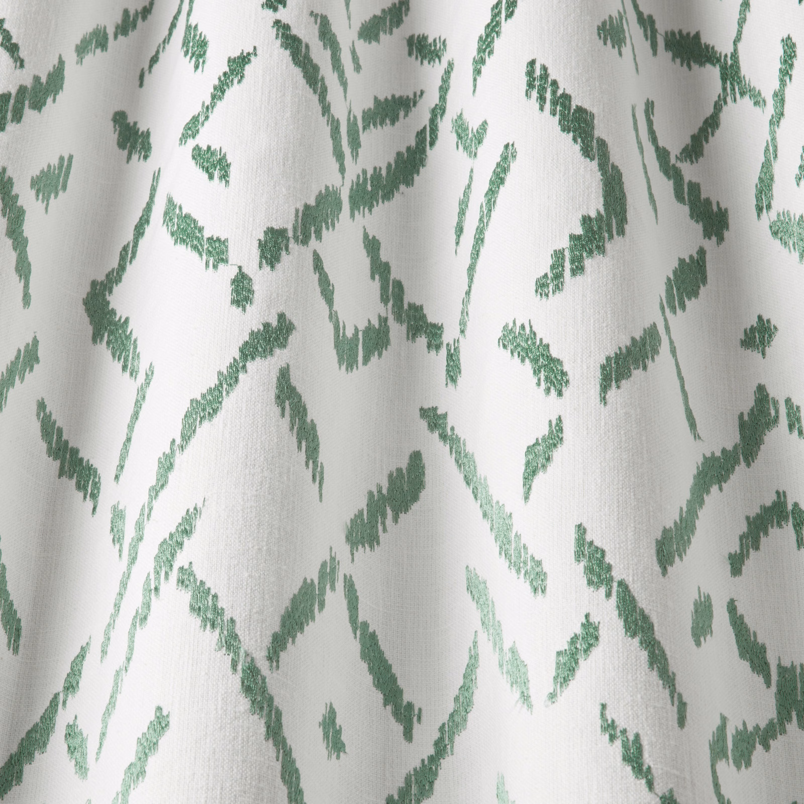 Off-white cotton fabric with sage green wavy abstract marks