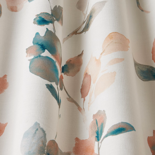 Painterly coral and teal leaf motif on a soft cream cotton base