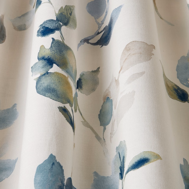 Painterly cornflower and sage leaf motif on a cream cotton fabric swatch