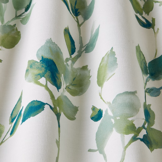 Cream cotton fabric with painterly sage and teal wavy leaf motifs