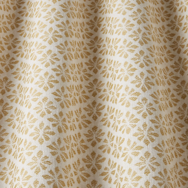 Cream cotton fabric with repeating barley-gold leaf motifs and a subtle woven texture