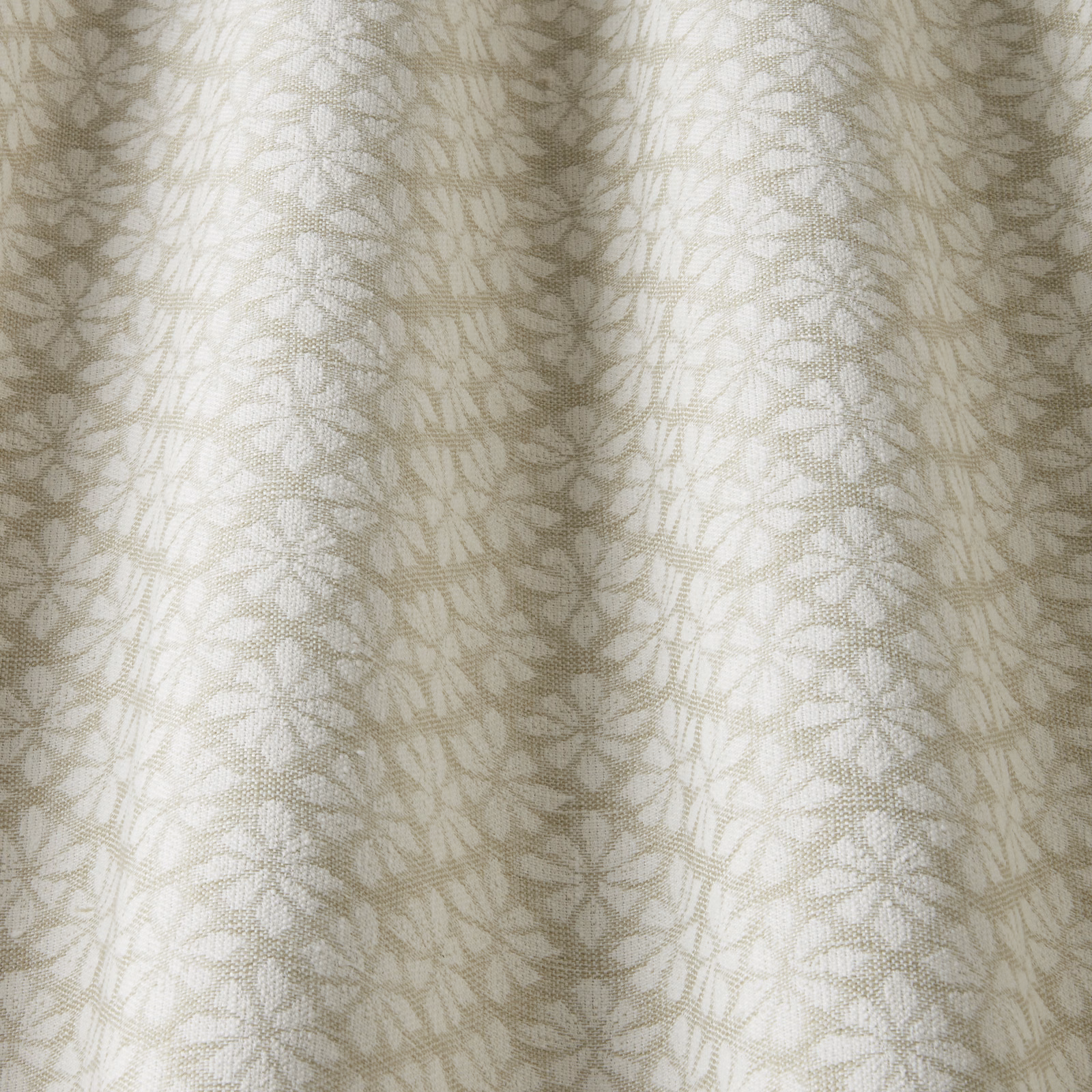 Pale cream cotton fabric with small sage leaf motif and subtle woven texture