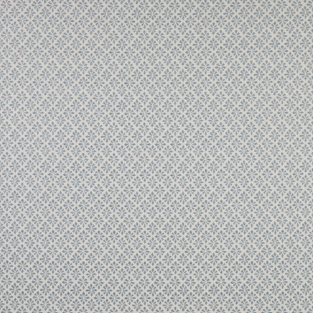 Close-up of pale cotton fabric with tiny denim-blue geometric floral diamonds