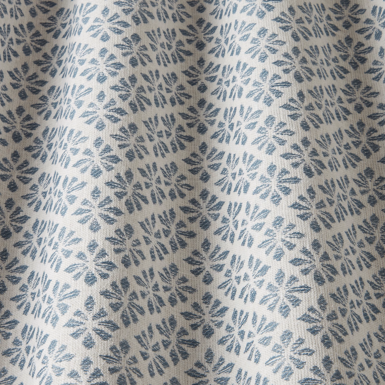 Denim blue leaf motif on an ivory woven cotton fabric swatch