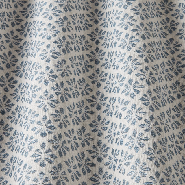Denim blue leaf motif on an ivory woven cotton fabric swatch