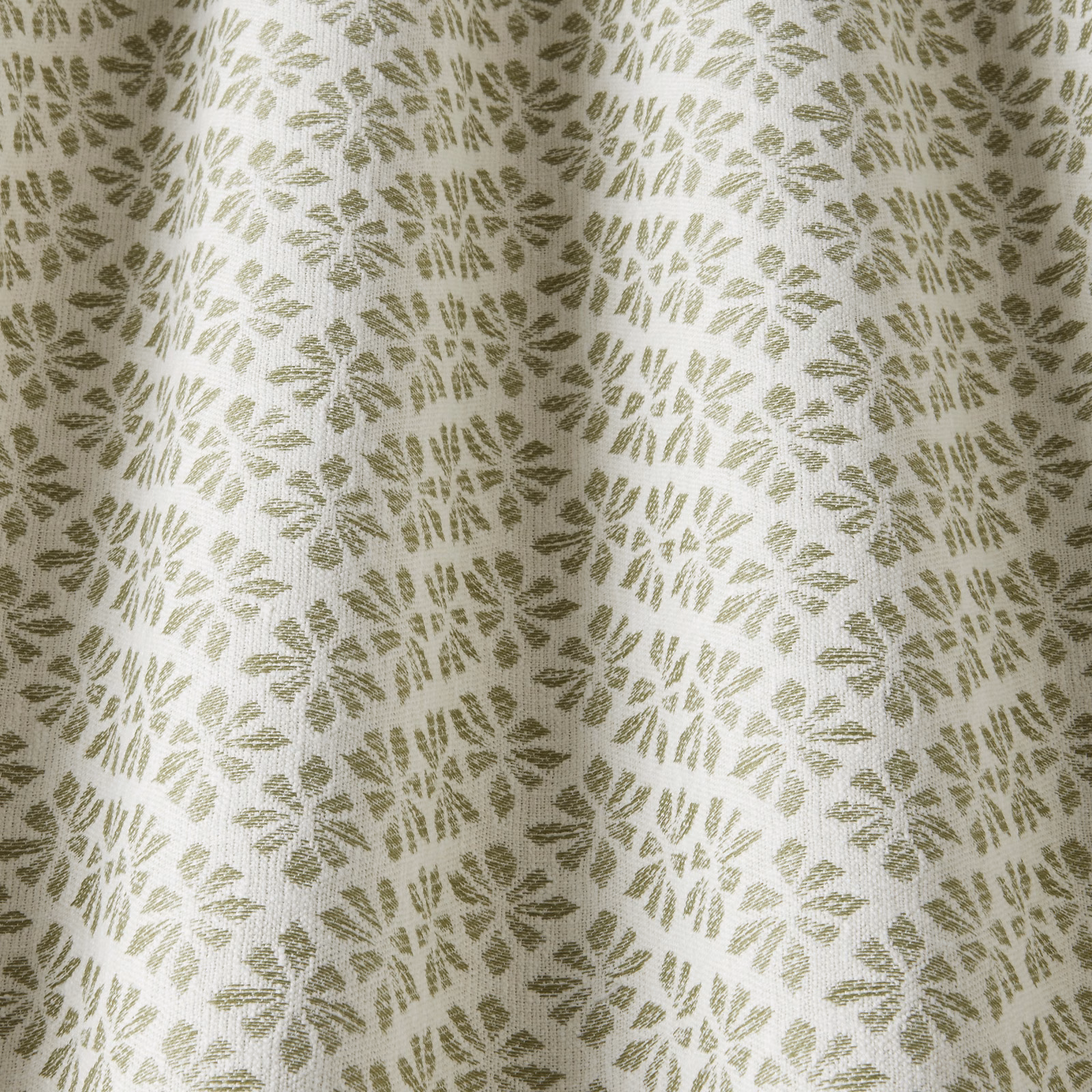 Pale cotton fabric with sage-green floral motifs and a softly textured weave