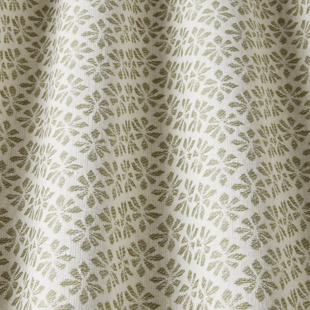 Pale cotton fabric with sage-green floral motifs and a softly textured weave