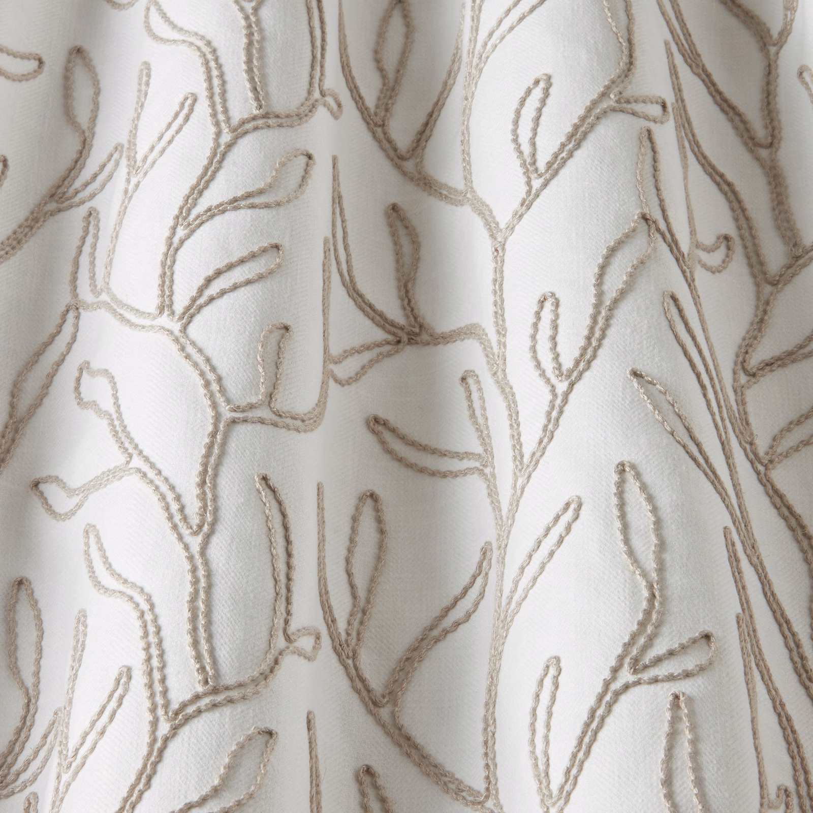 Cream cotton fabric with raised twig embroidery in soft taupe