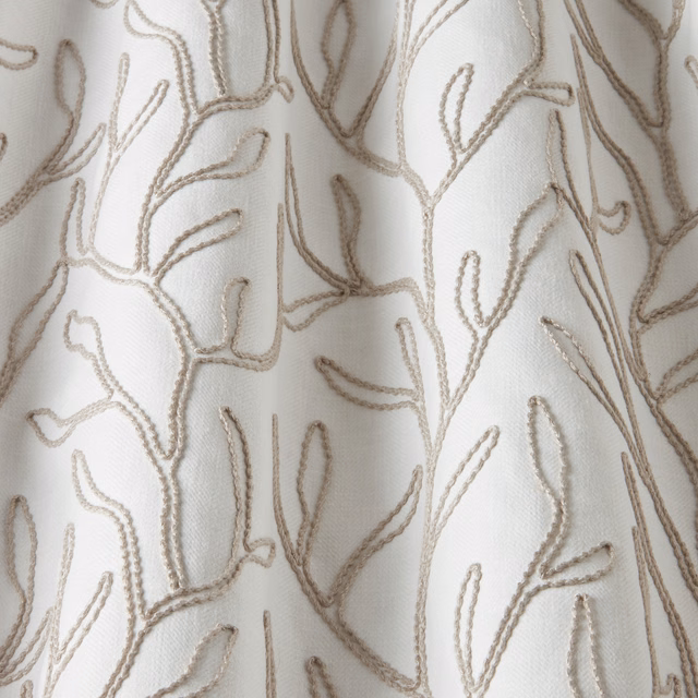 Cream cotton fabric with raised twig embroidery in soft taupe