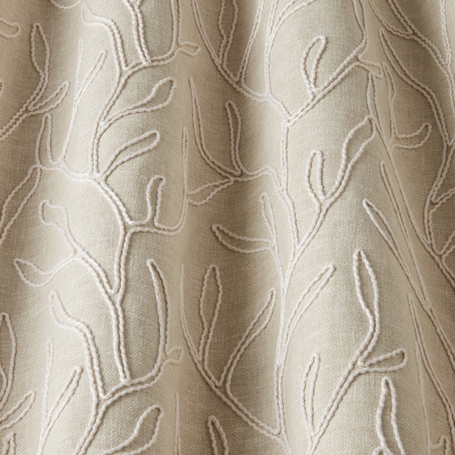Cream cotton fabric with raised twig motif in a soft organic repeat