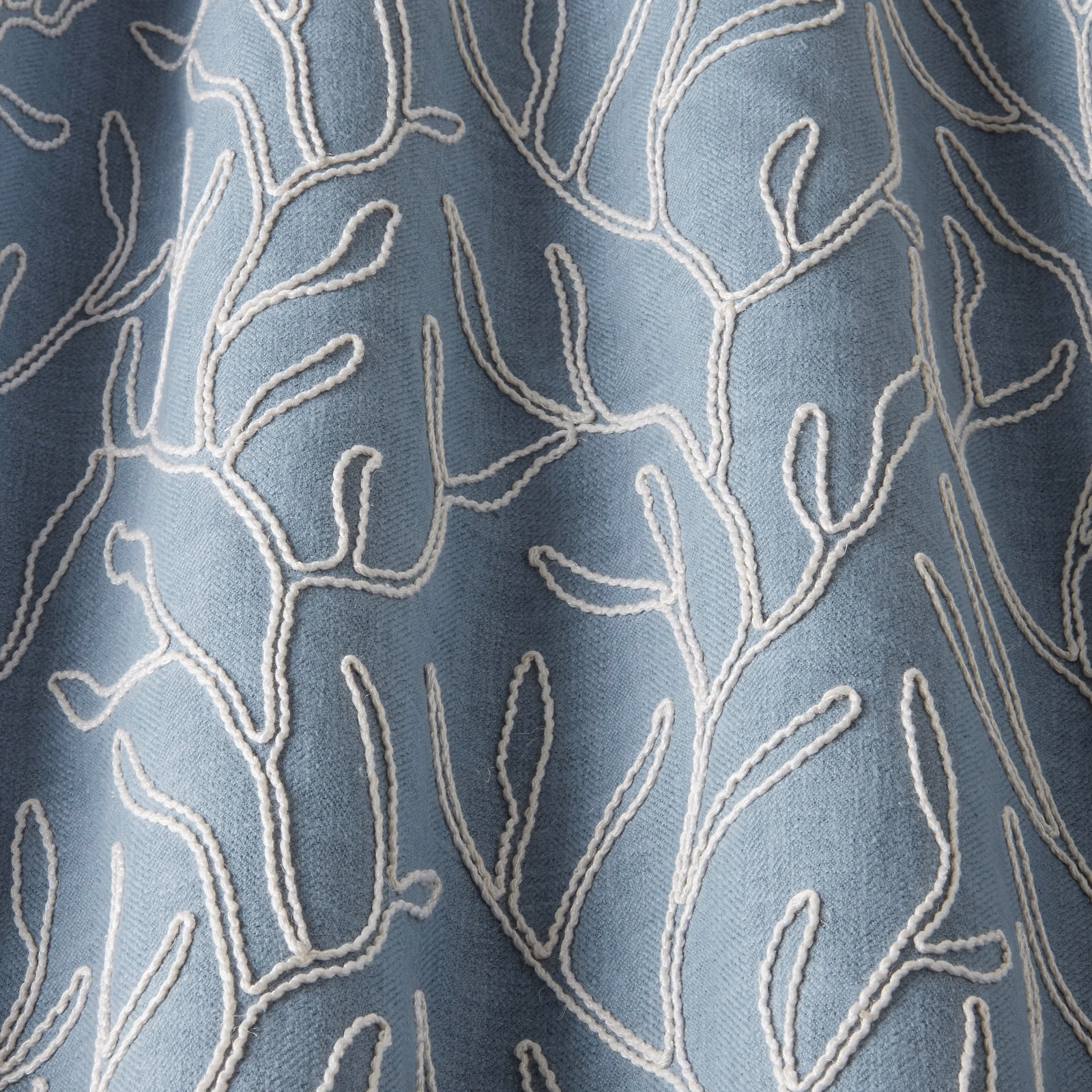Sky blue cotton fabric with raised ivory wavy branch embroidery