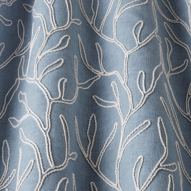 Sky blue cotton fabric with raised ivory wavy branch embroidery