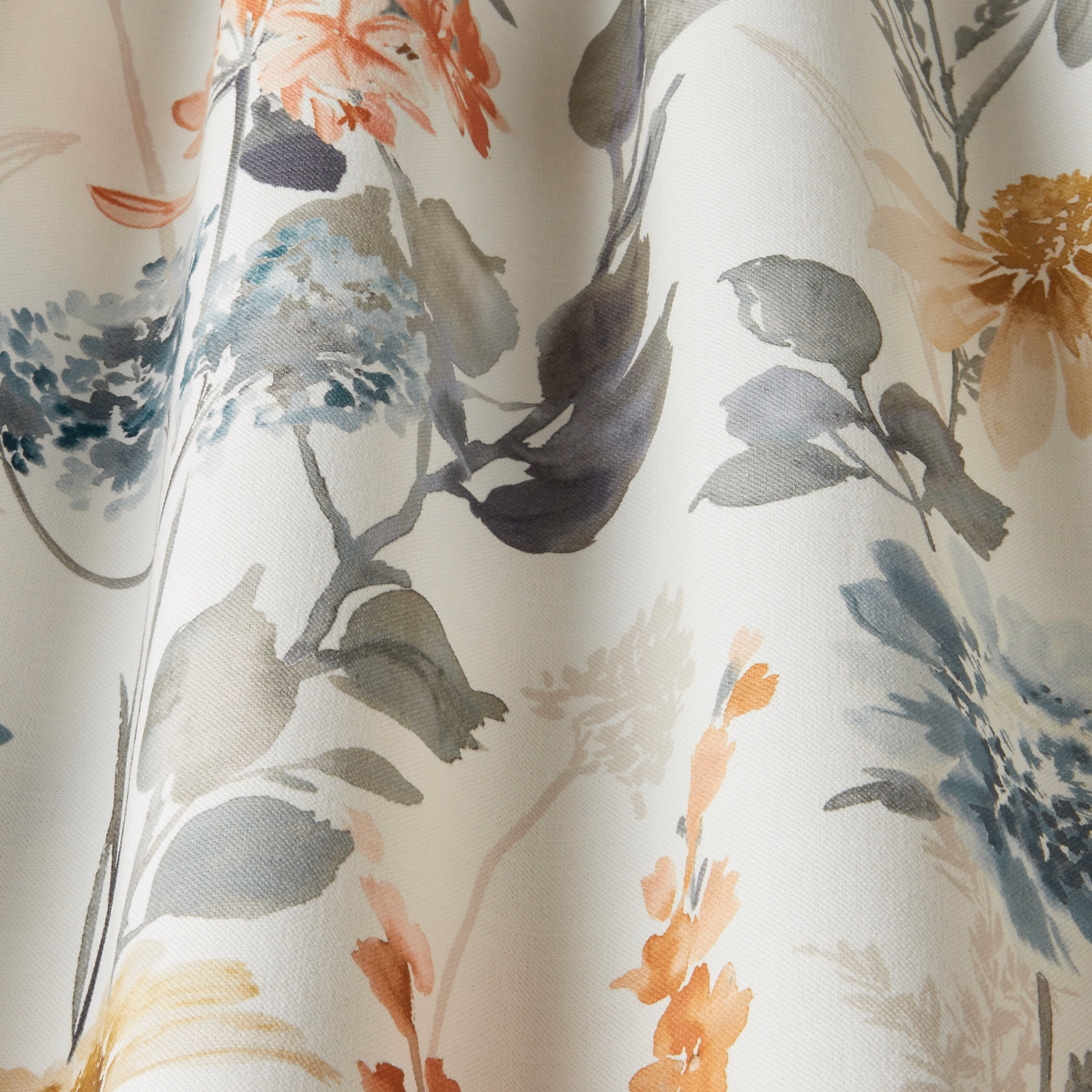 Watercolour floral cotton fabric with coral, blue-grey and olive leaves on a cream ground