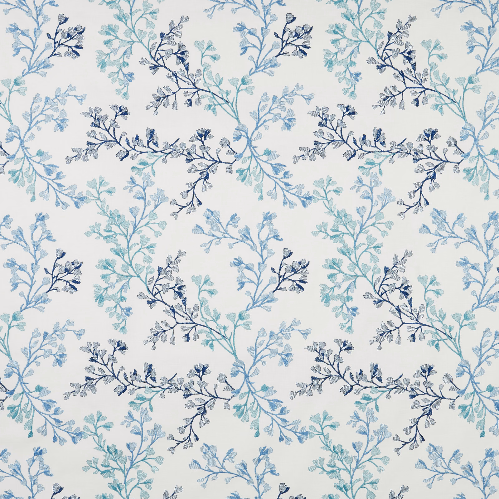 Cream cotton fabric with trailing leaf branches in cornflower, teal and navy