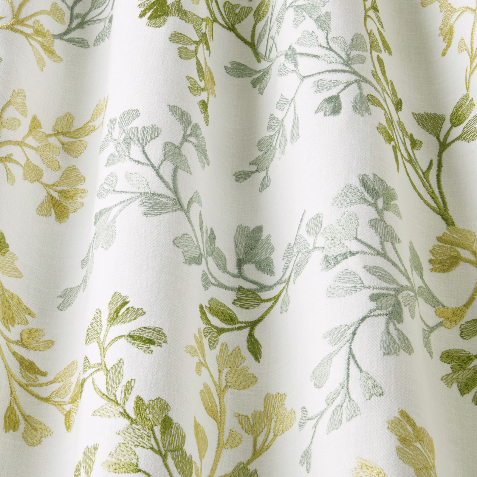 White cotton fabric with trailing sage and willow green leafy stems