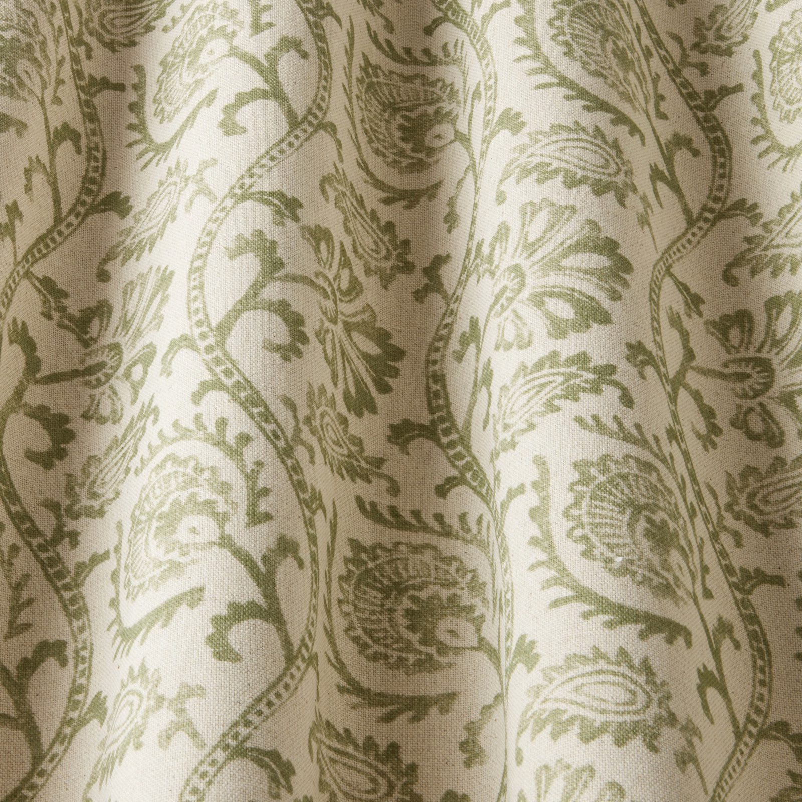 Sage green scrolling floral fabric on an ivory ground with a woven texture