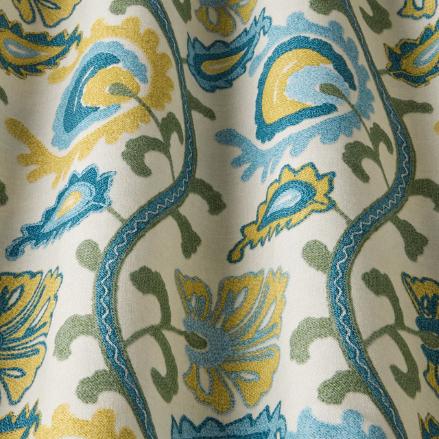 Teal, yellow and green floral fabric swatch on a pale ground with wavy stems