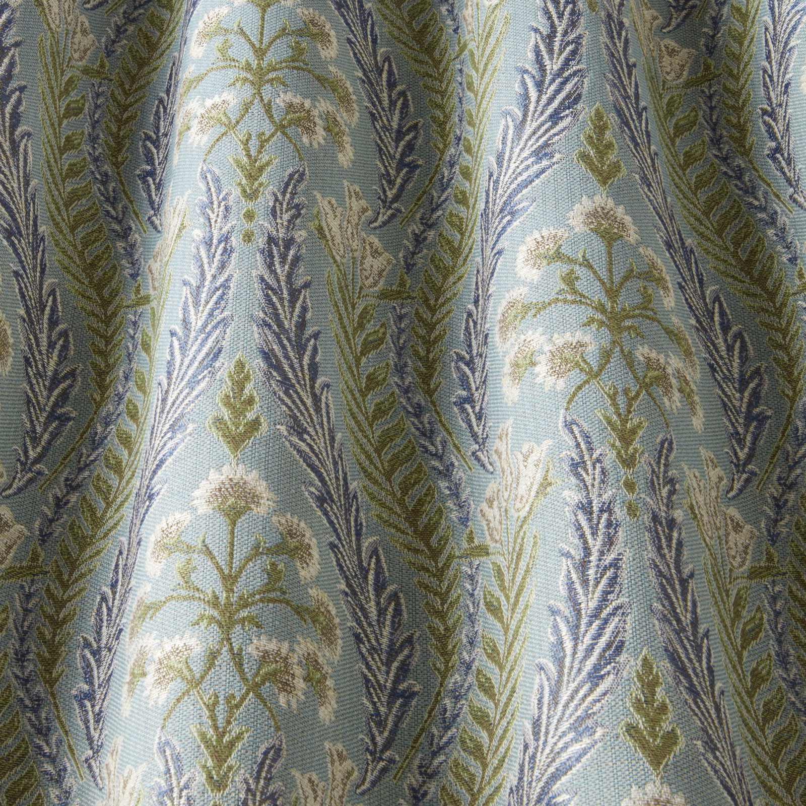 Pale glacier blue woven fabric with navy and olive leaf motif