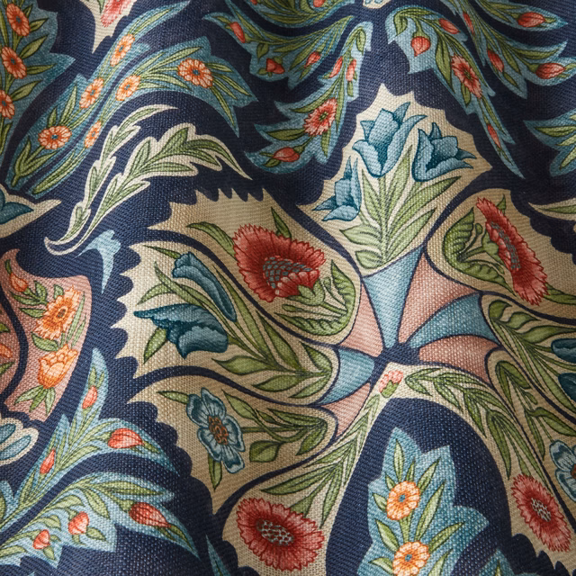 Dark navy floral fabric with scrolling leaves and jewel-toned blooms