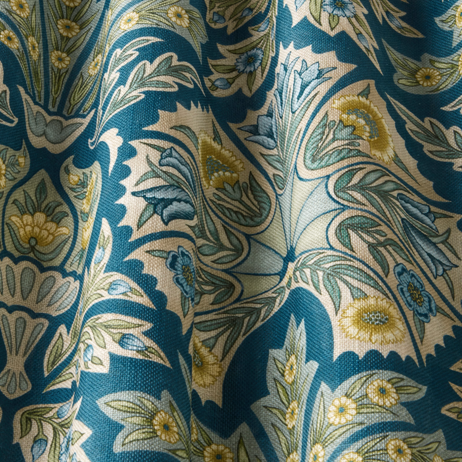 Teal floral woven fabric with cream scrolling leaves and yellow flower accents