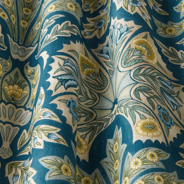 Teal floral woven fabric with cream scrolling leaves and yellow flower accents
