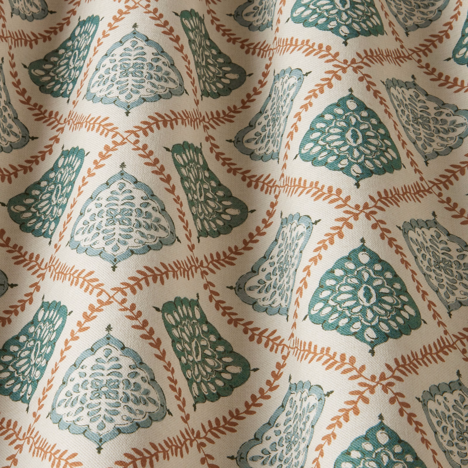 Ivory fabric swatch with sea green and aqua scalloped motifs and rust leaf trails