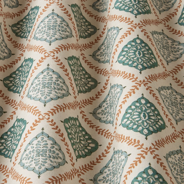Ivory fabric swatch with sea green and aqua scalloped motifs and rust leaf trails