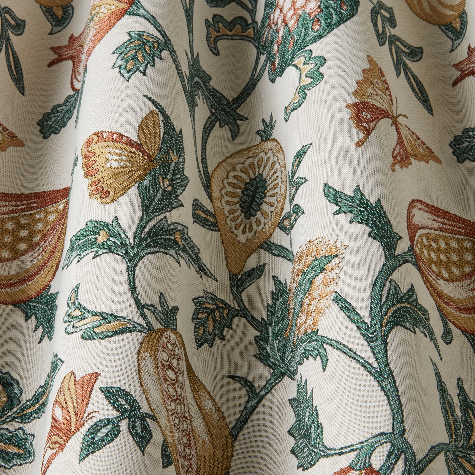 Cream botanical fabric with green, papaya and ochre floral motifs