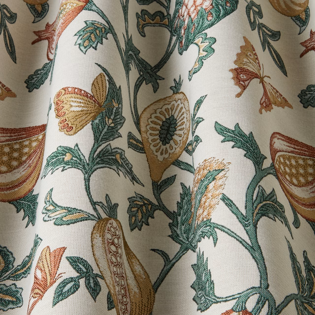 Cream botanical fabric with green, papaya and ochre floral motifs
