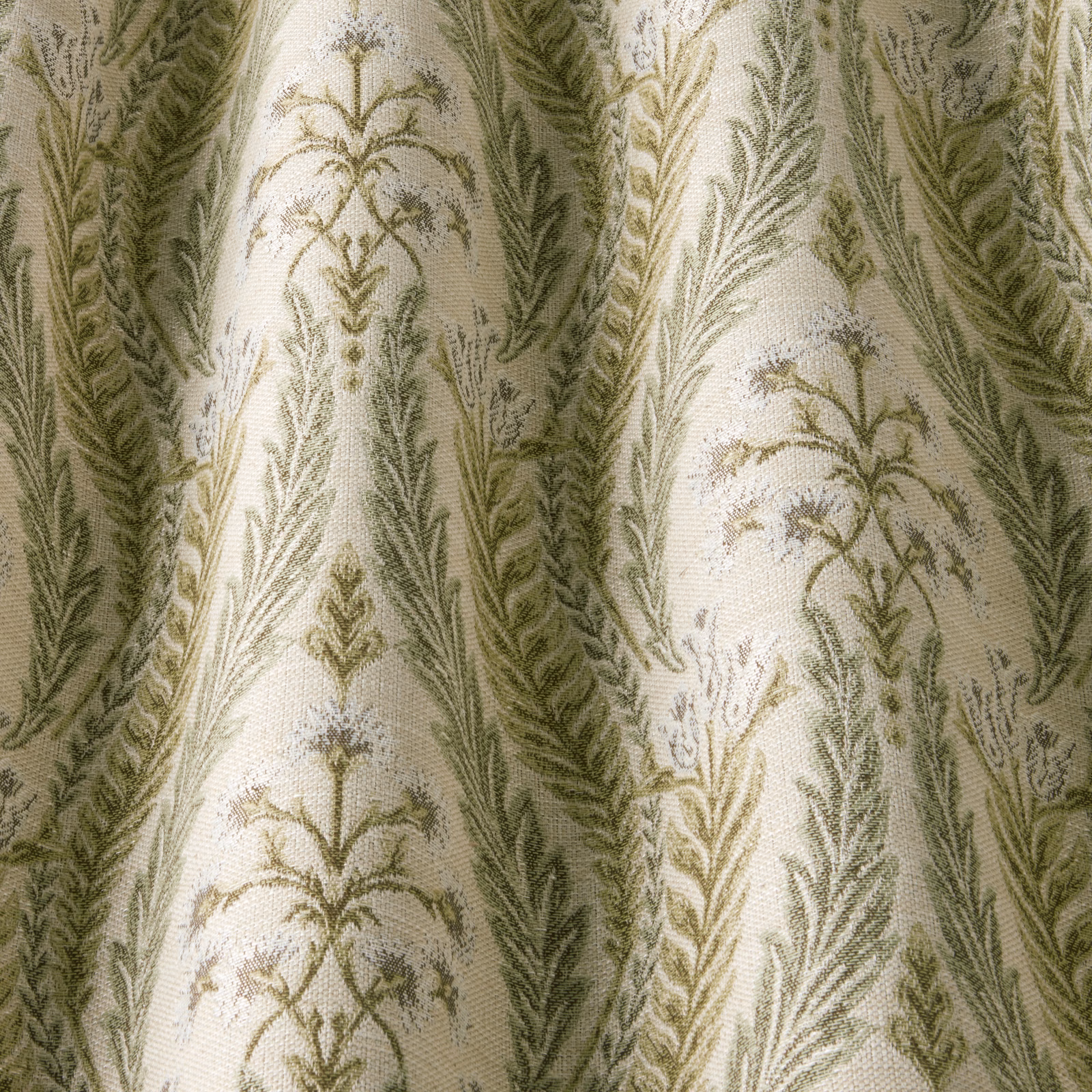 Sage green botanical woven fabric with arched trailing leaf motifs on ivory ground