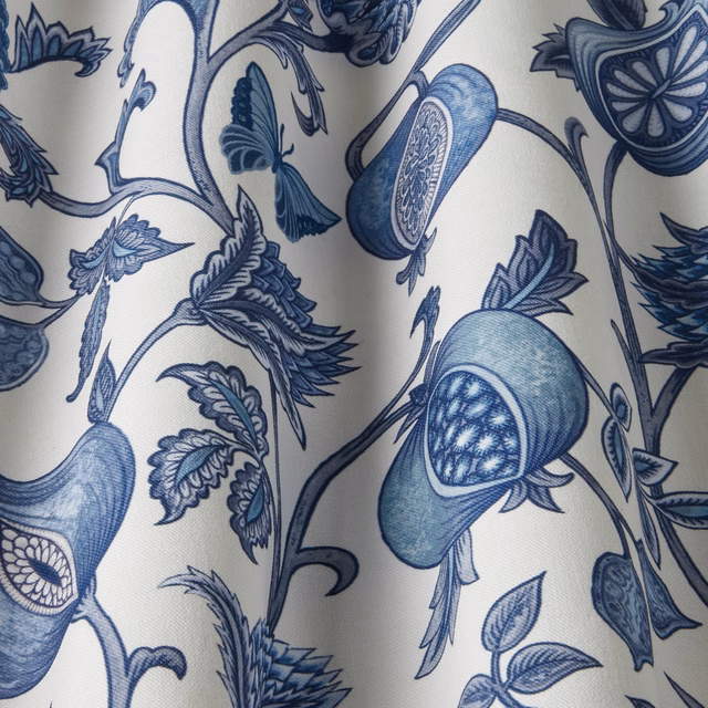 Cream fabric swatch with flowing sapphire blue botanical print and trailing stems