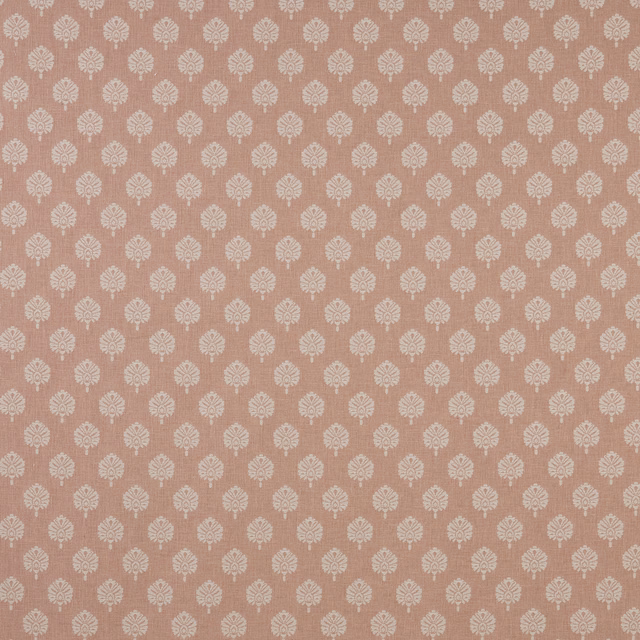 Blush pink patterned fabric with small ivory floral motifs on a flat woven ground
