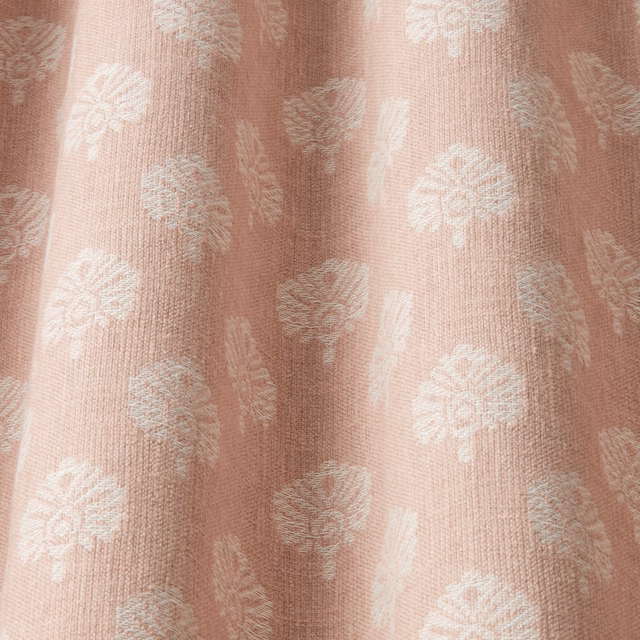 Blush pink jacquard fabric with pale botanical motif and textured woven ground