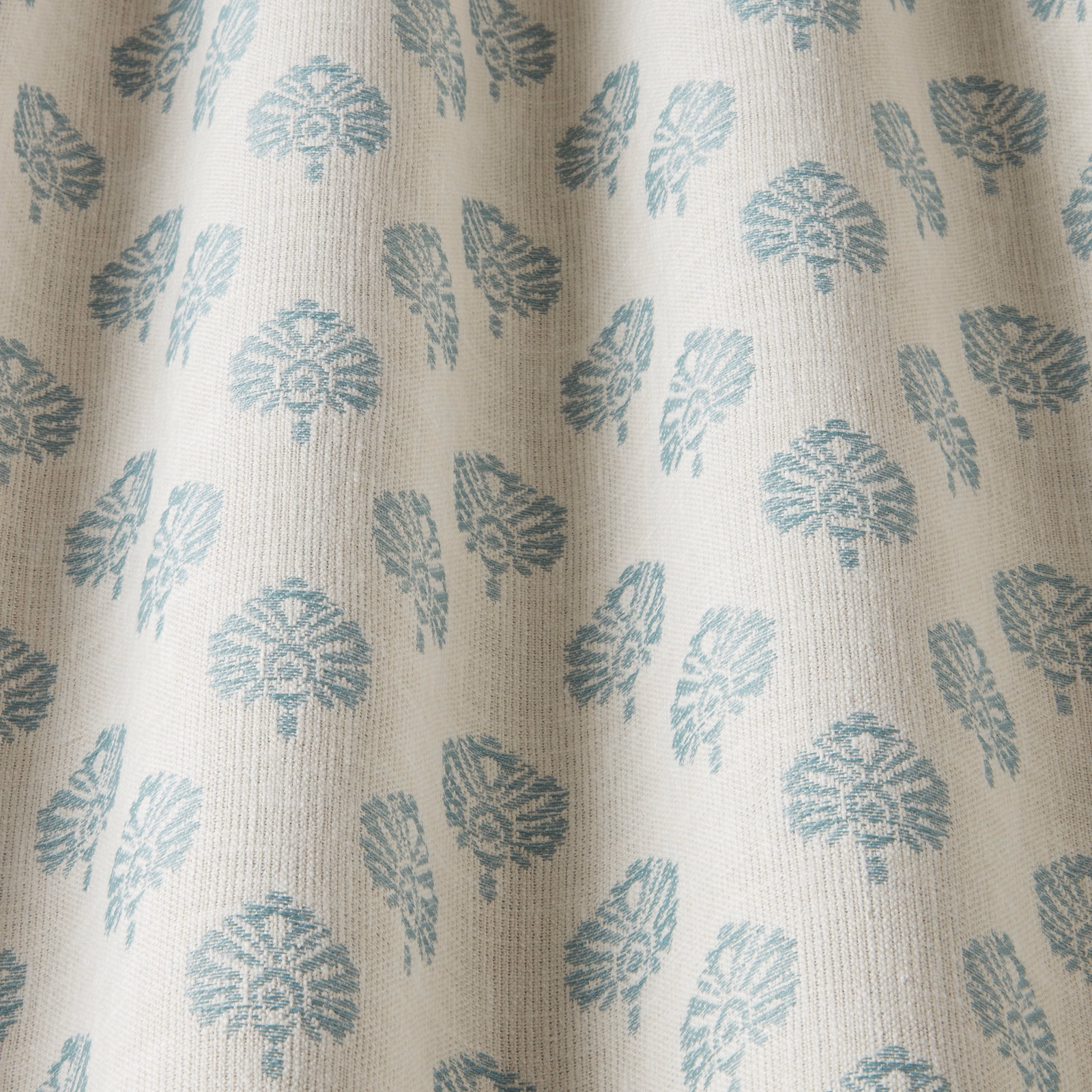 Cream fabric with small glacier blue botanical motif and subtle woven texture
