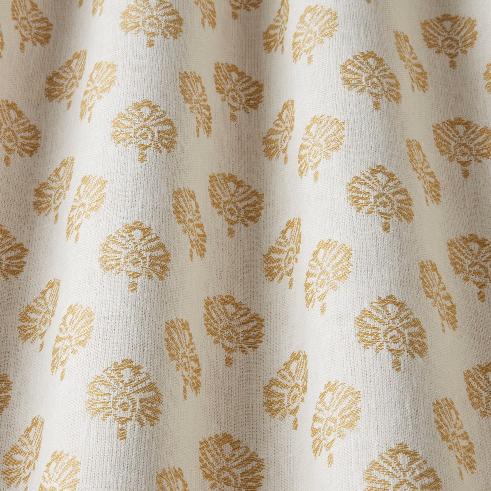 Ochre botanical motif on a soft ivory woven fabric