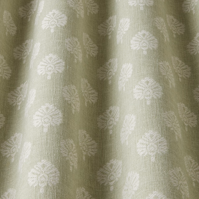 Sage green woven fabric with pale botanical motif and soft vertical folds