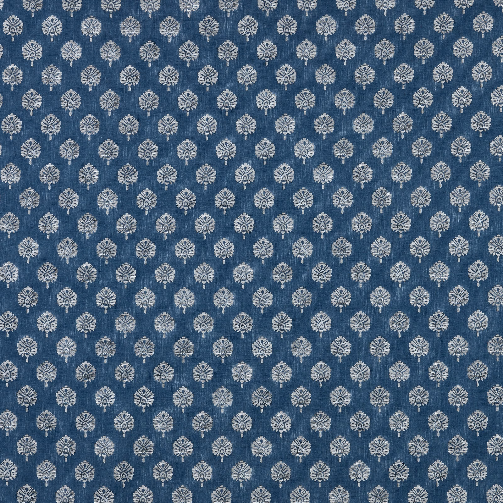Deep sapphire blue fabric with small pale floral motifs in a tight repeat
