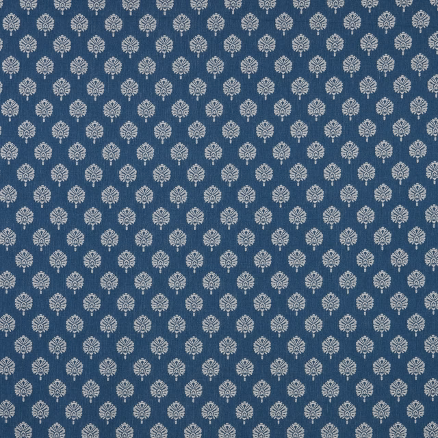 Deep sapphire blue fabric with small pale floral motifs in a tight repeat