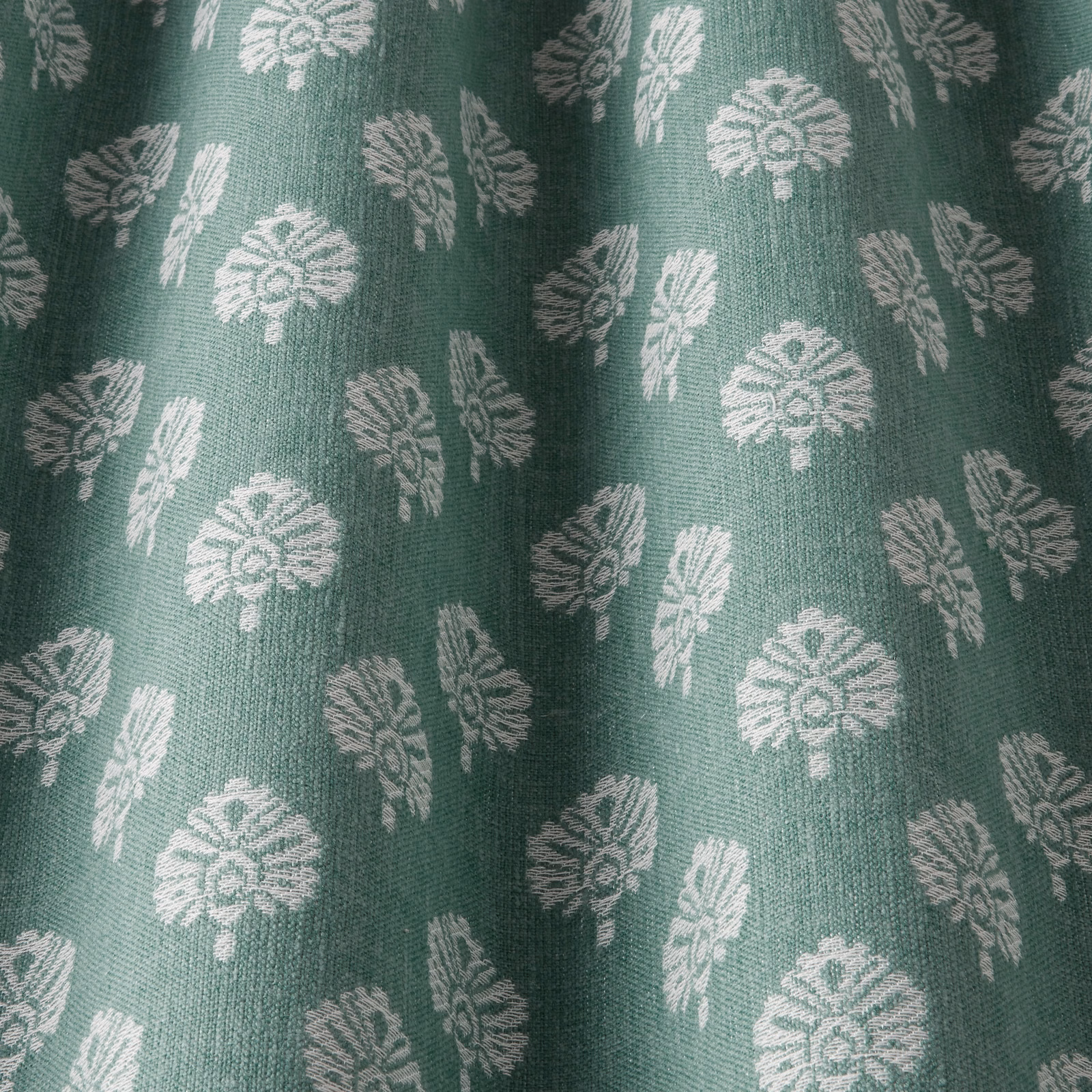 Sea-green woven fabric with small pale leaf motifs and a subtle textured surface